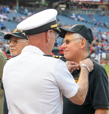 VWC_Public_Engagement_Chief,_Commander_Brian_Wierzbicki_presents_Vietnam_Veteran_Lapel_Pins_during_The_Washington_National_s_pre-game.